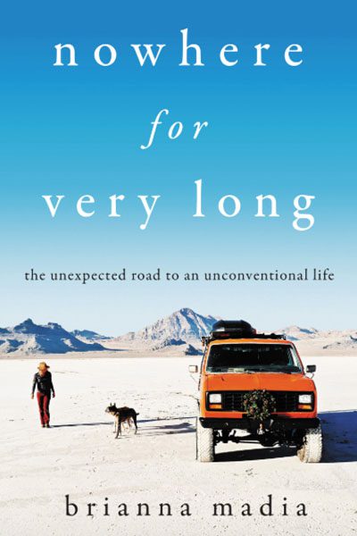 Cover of "Nowhere for Very Long" by Brianna Madia. A woman and a dog walk near an orange van on a vast, dry landscape under a clear blue sky.